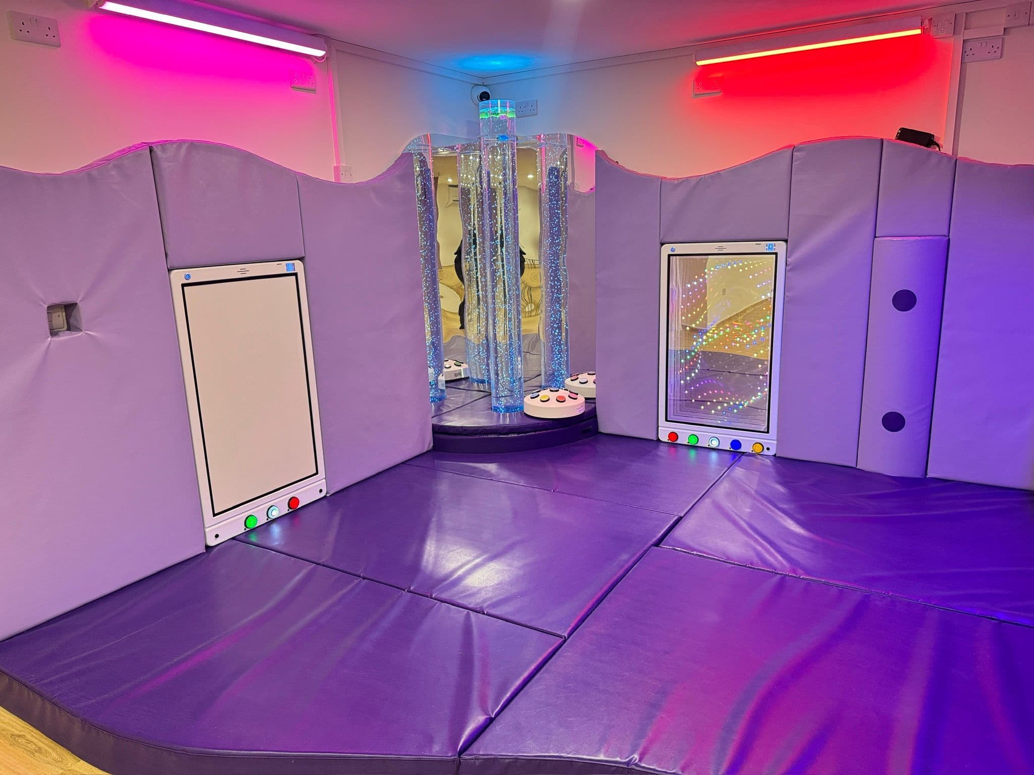 Sensory room with gentle pink lighting for calming experiences