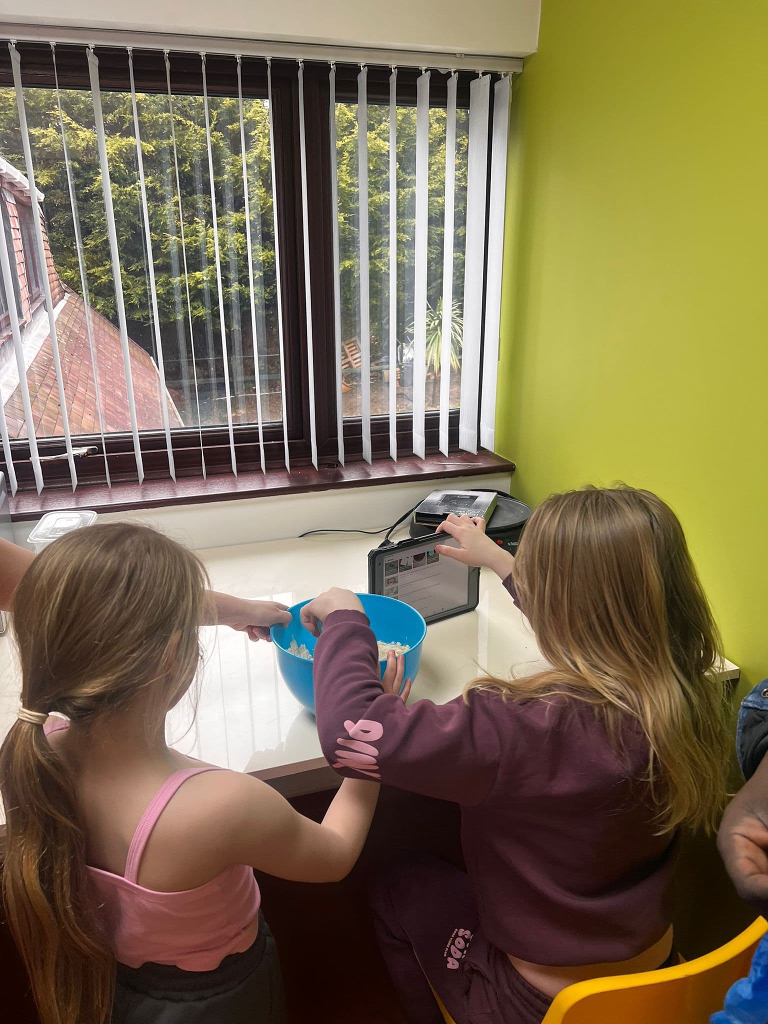 Children and staff baking together during a supported activity session