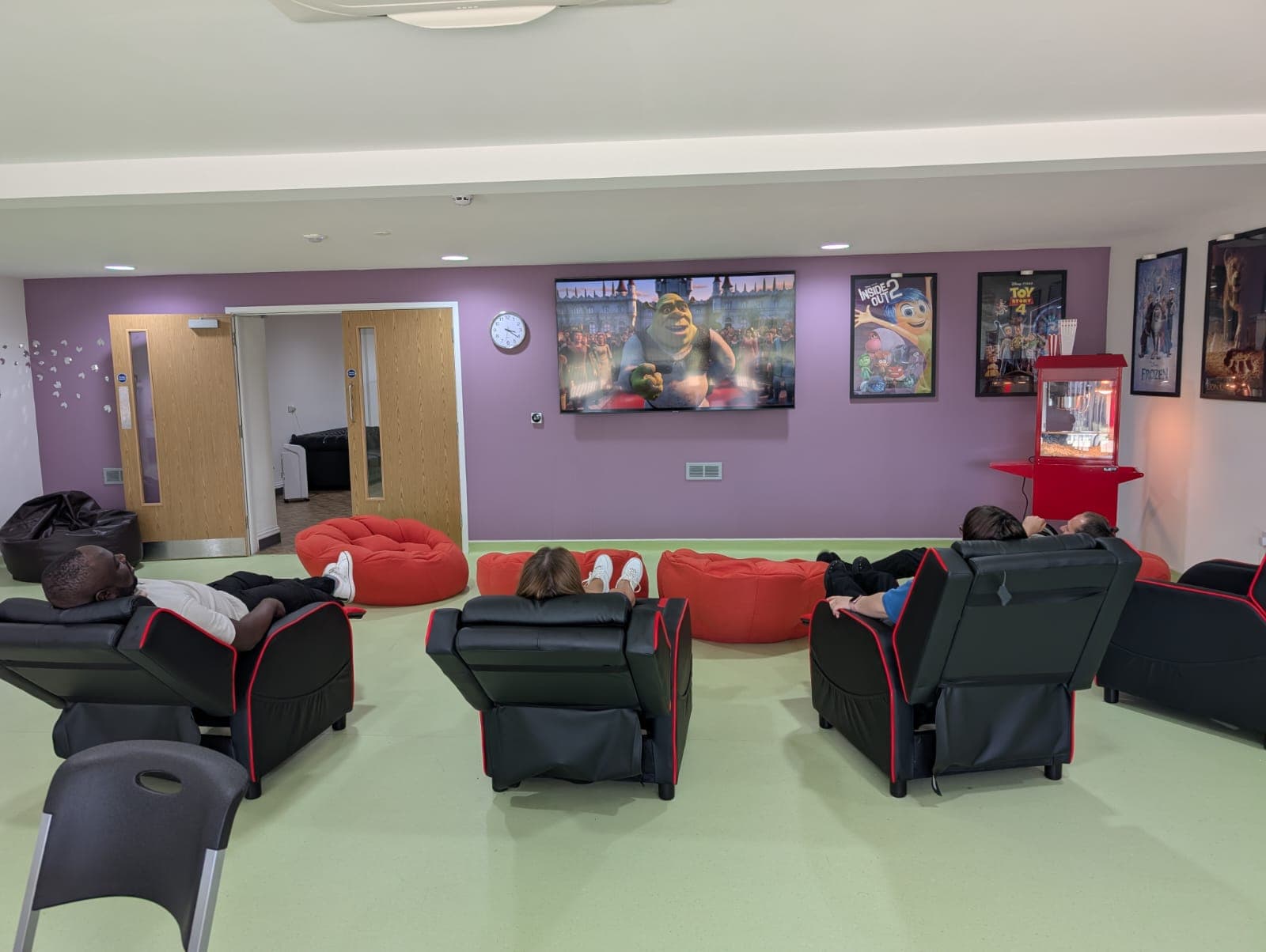 Children relaxing in recliner chairs during a cinema session