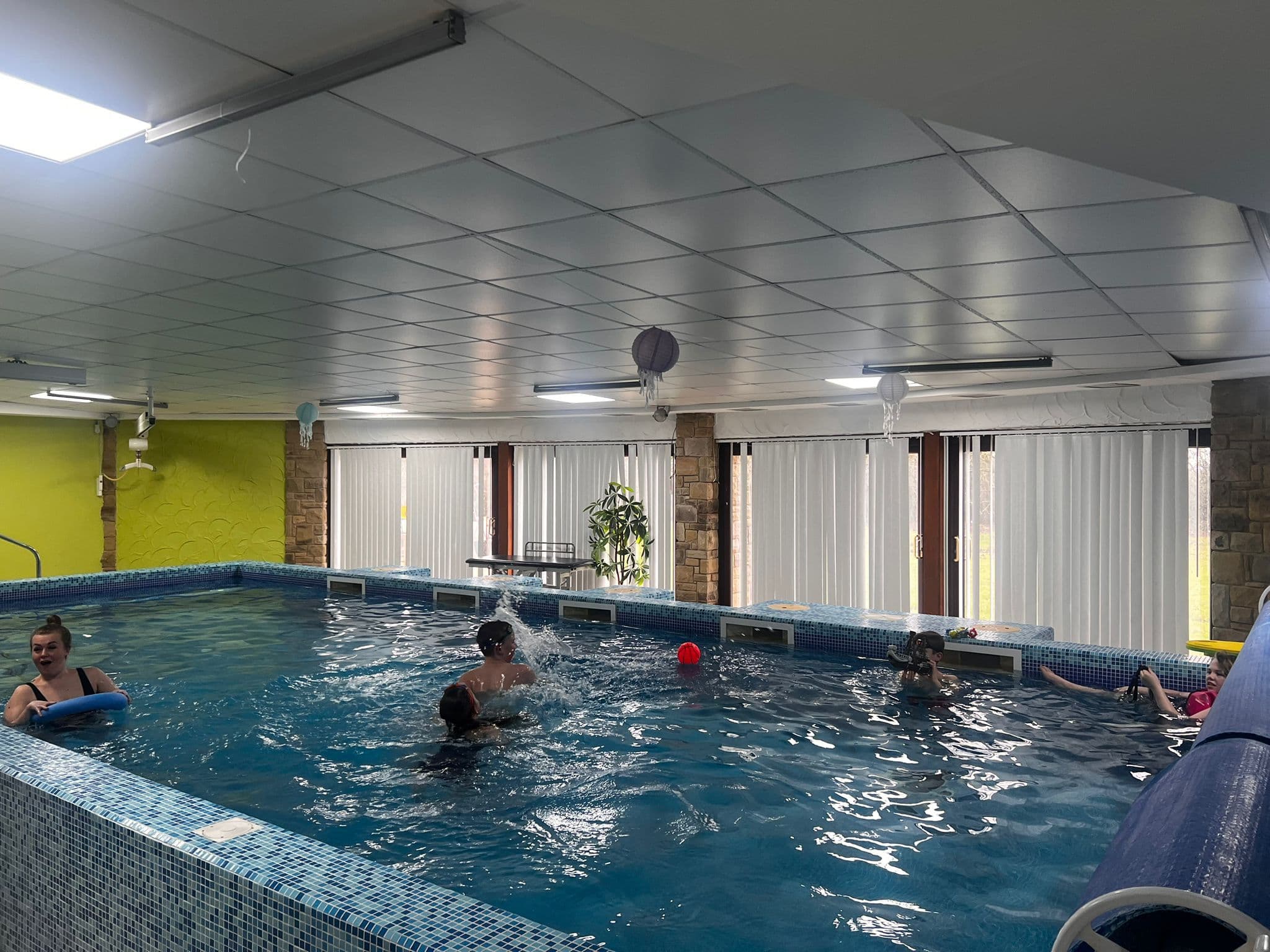 Heated hydrotherapy pool with children enjoying a supervised session